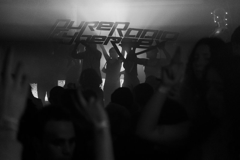 crowd at pure radio cybersex, with the sign being held up in the background